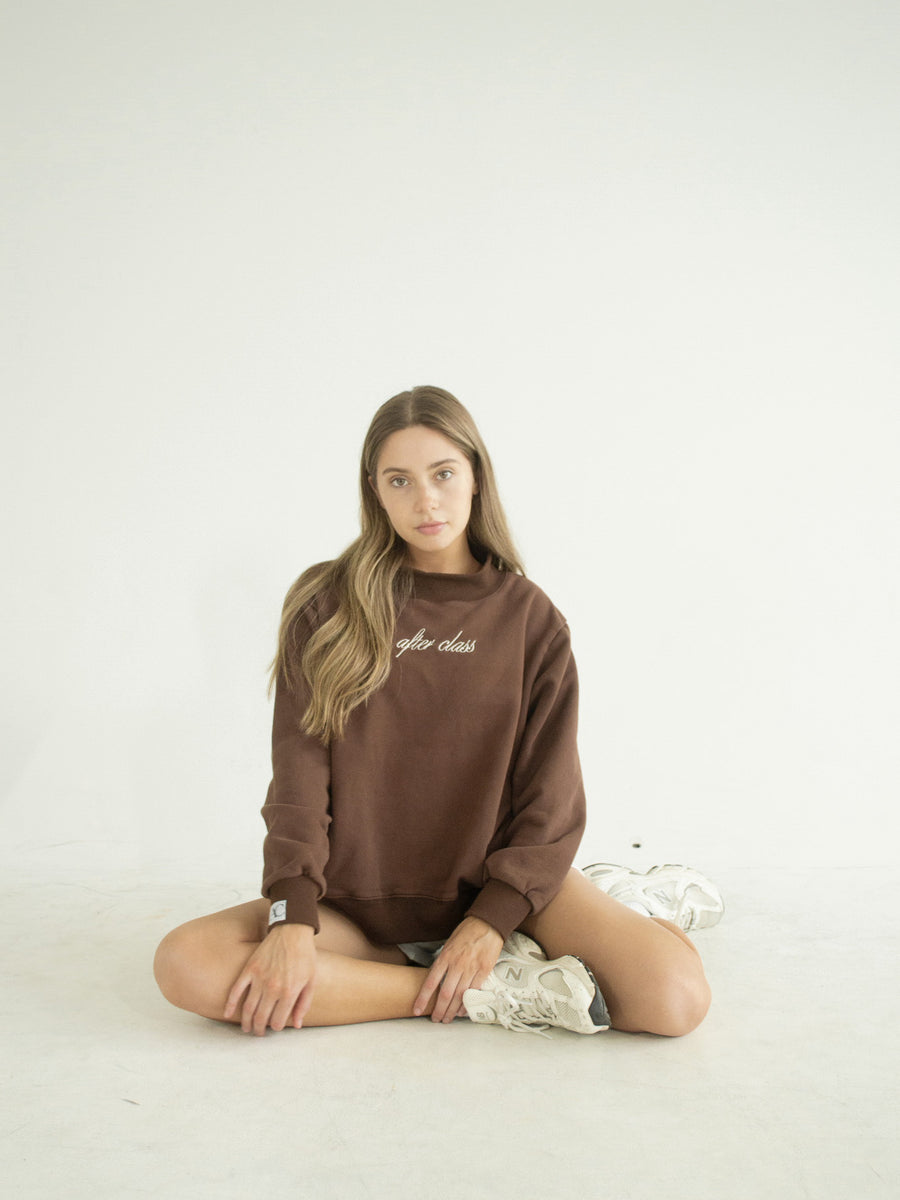 Ballet Rodeo chocolate-brown mockneck sweatshirt with 'after class' script embroidery, worn seated