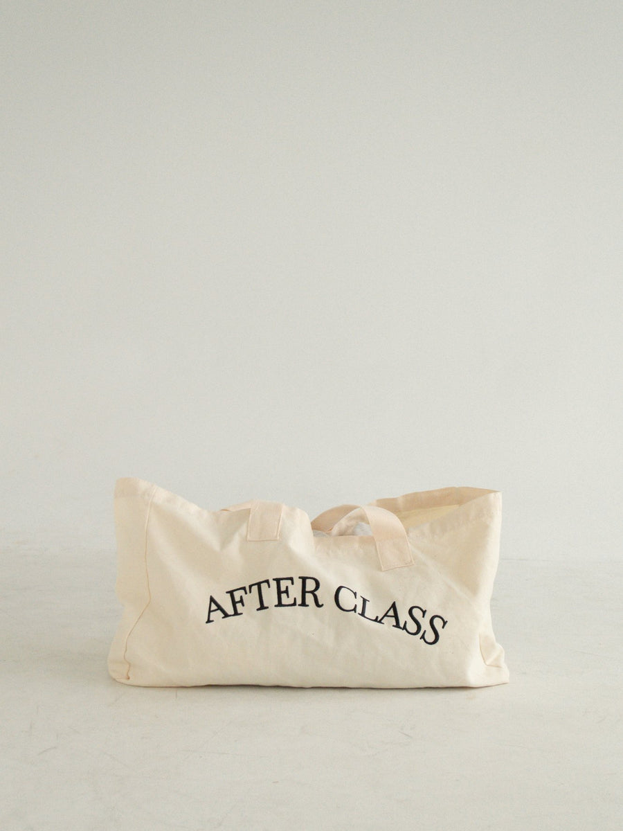 The After Class tote in natural cotton canvas with arched black 'AFTER CLASS' lettering